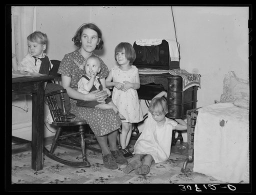Mrs. Shotbang with her four children she delivered herself. Husband broke his foot early this spring. About time baby was to be born they ran short of coal and bed clothing, Mrs. Shotbang had to take care of the newly-born baby and the rest of the family, cutting fence posts for fuel. The family alm