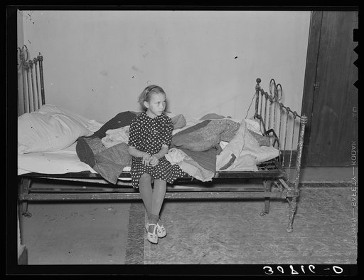 Daughter of A.O. Ryland. Family used quilts as mattresses. Near Williston, North Dakota