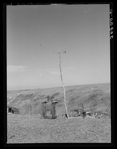 Sewing machine and makeshift weathervane near Williston North Dakota