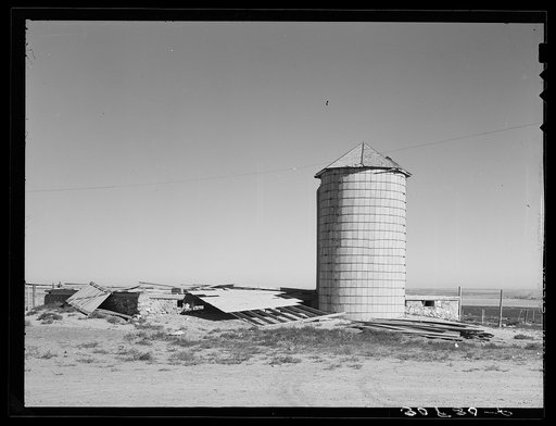 Old silo and remains of barn wrecked by wind near Williston, North Dakota