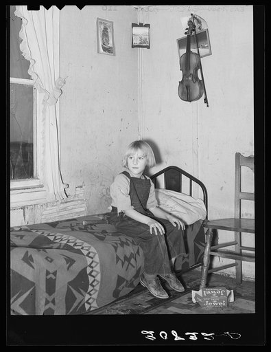 Child of James Strunk in corner of living room. Near Wheelock, North Dakota