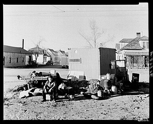 Williston, North Dakota. Theodore F. Jeffries, squatter on street corner of Williston, North Dakota. This is an old truck, bright red, with the body removed from the chassis which he is fixing up for his winter home having lost his home to the loan company. County FSA (Farm Security Administration) 