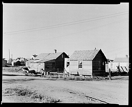 Houses that were moved to town from the country by General Jackson, former farmer now living in Plentywood, Montana. At one time he had 125 cattle; the other day he sold last cow. Buildings left in the country were usually wrecked or the lumber stolen for building or fuel. Lumber is very costly in t