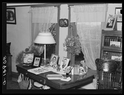 Living room table in the home of George Bolster, founder of Plentywood, Montana. Note Bible covered with doily