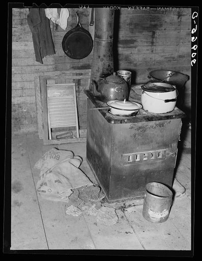 Kitchen stove and bag full of cow dung used as fuel. Sheridan County, Montana