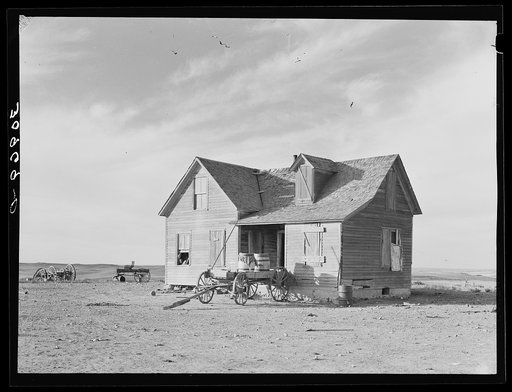 Untitled photo, possibly related to: Farmhouse and wagon used for hauling water. Sheridan County, Montana