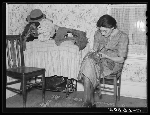 Mrs. Gallagher patching clothes for her children. Wife of former farmer, now living in Crosby, North Dakota