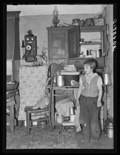 Girl in corner of kitchen of John Baker's farm home. Divide County, North Dakota