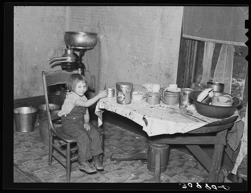 Daughter of John Baker in kitchen of the farm home. Divide County, North Dakota