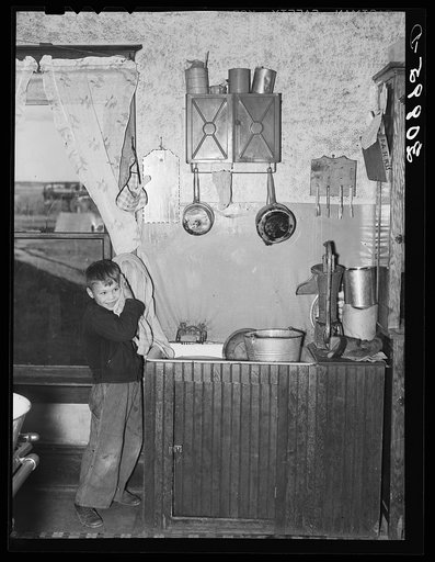 Boy washing his face. Williams County, North Dakota