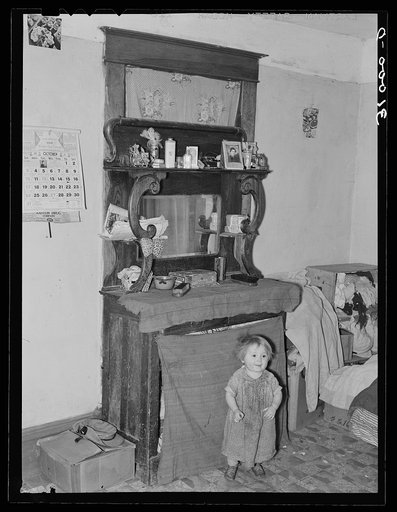Baby in front of dresser in John Baker's farm home. Divide County, North Dakota