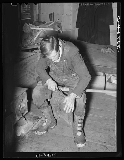 Gold miner filing his pick. Two Bit Creek, near Deadwood, South Dakota