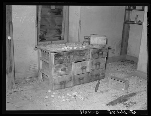 Chemical cabinet in assaying office at Two Bit Creek. Note the cupels for accommodating sample ore. South Dakota