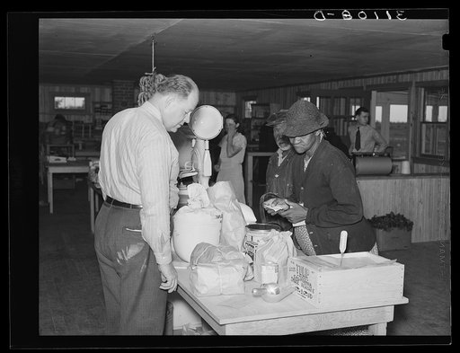 Southeast Missouri Farms. Making a purchase at cooperative store. La Forge, Missouri