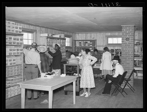 Southeast Missouri Farms. Customers examining stock of cooperative store.  La Forge project, Missouri