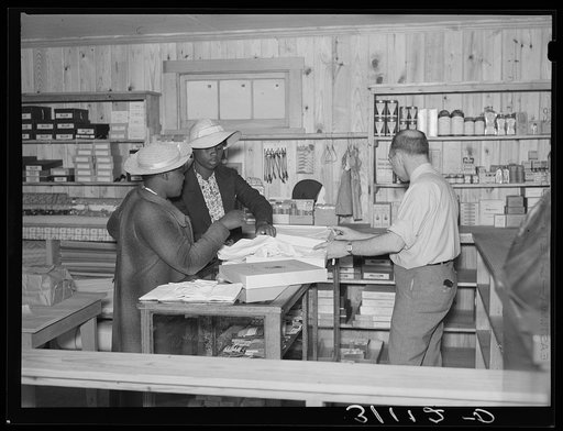 Southeast Missouri Farms. Making a purchase at cooperative store. La Forge project, Missouri