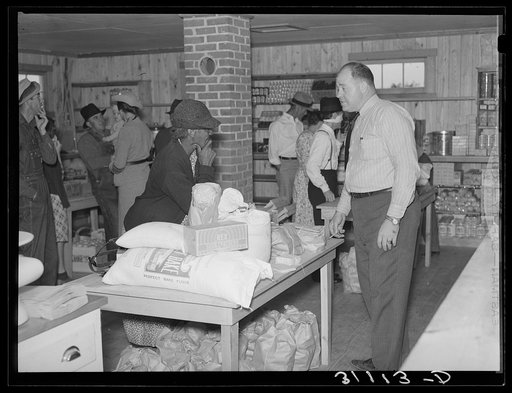Making a purchase at cooperative store. La Forge project, Missouri