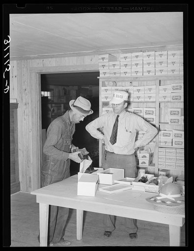 Southeast Missouri Farms. Buying pair of shoes at cooperative store. La Forge project, Missouri