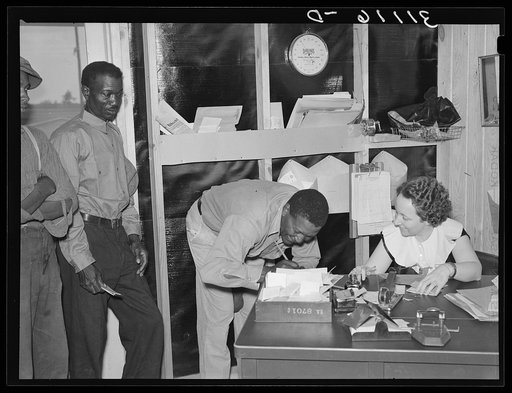 Southeast Missouri Farms. FSA (Farm Security Administration) client signing papers. FSA office, La Forge project, Missouri