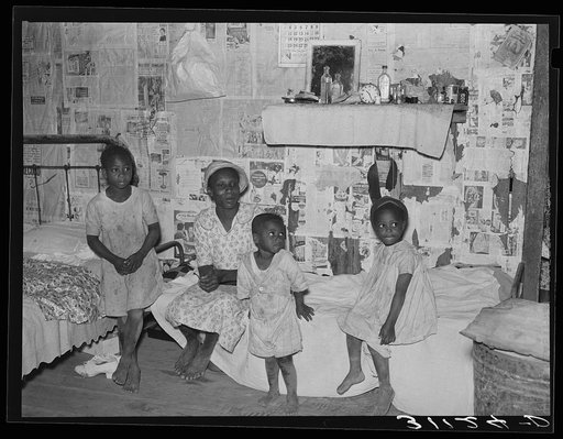 Sharecropper family in old home before moving to La Forge project, Missouri