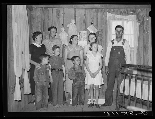 Sharecropper family in living room of shack home. La Forge project, Missouri