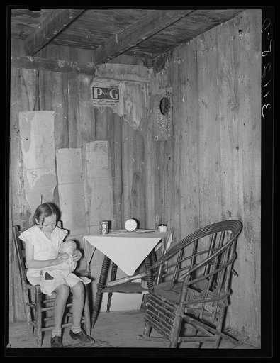 Southeast Missouri Farms. Girl in corner of living room of old shack. La Forge, Missouri