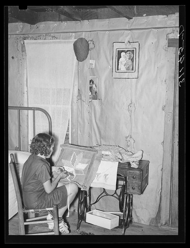 Southeast Missouri Farms. Girl making a hooked rug in bedroom of shack home. La Forge, Missouri