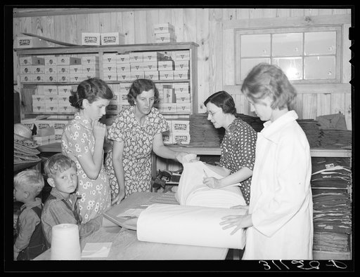 Southeast Missouri Farms. Examining yard goods in cooperative store. La Forge project, Missouri