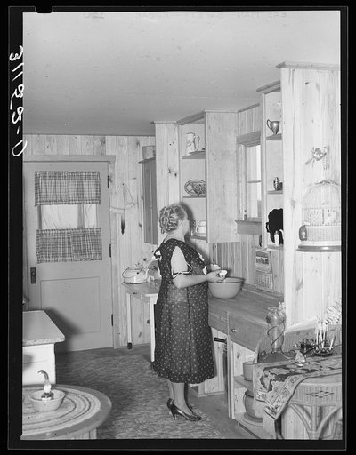Southeast Missouri Farms. Wife of client in kitchen of new home. La Forge project, Missouri