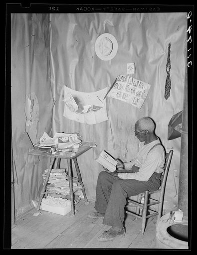 New Madrid County, Missouri. Old Negro sharecropper reading the Bible in his living room