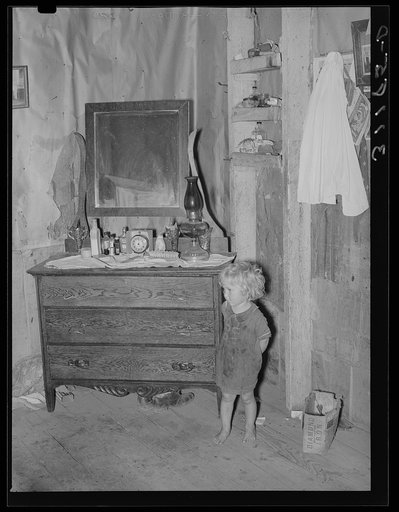 Southeast Missouri Farms. Daughter of FSA (Farm Security Administration) client, former sharecropper, in corner of shack living room and bedroom