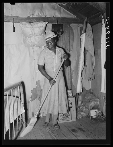 Southeast Missouri Farms. Wife of FSA (Farm Security Administration) client, former sharecropper, sweeping floor in shack home
