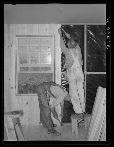 Southeast Missouri project. Field house erection. Lining interior walls with vertical boards