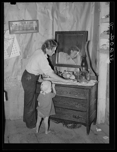 Southeast Missouri Farms. Mother and child in bedroom of sharecropper home