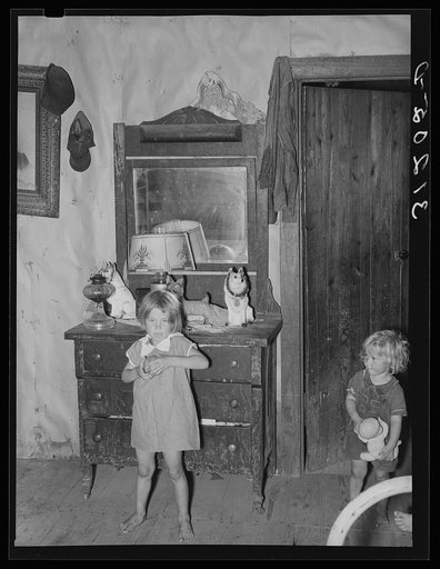 Southeast Missouri Farms. Children of FSA (Farm Security Administration) client, former sharecropper, in bedroom of shack home. Note sign "God bless our home"