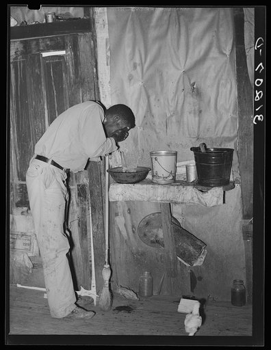 Southeast Missouri Farms. FSA (Farm Security Administration) client, former sharecropper, washing his face in former home