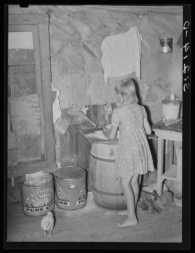 Untitled photo, possibly related to: Southeast Missouri Farms. Sharecropper's daughter and chicken in kitchen of shack home