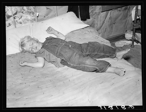Untitled photo, possibly related to: Southeast Missouri Farms. Sharecropper's child asleep on bed