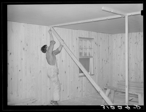 Untitled photo, possibly related to: Southeast Missouri project field. House erection. After ceiling is in place, plates are nailed for the partitions