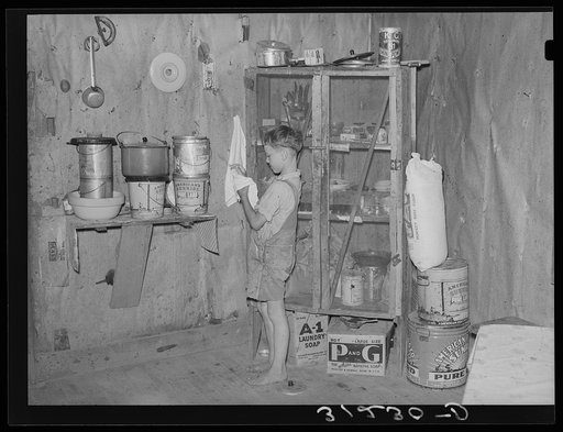 Southeast Missouri Farms. Child of sharecropper wiping hands in kitchen