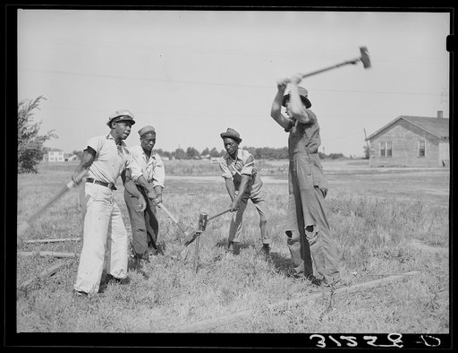 Driving stakes for Lasses-White show. Sikeston, Missouri