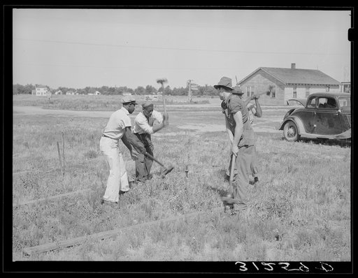 Untitled photo, possibly related to: Driving stakes for Lasses-White show. Sikeston, Missouri