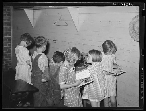 Children choosing books from the small school library near La Forge, Missouri. Southeast Missouri Farms school