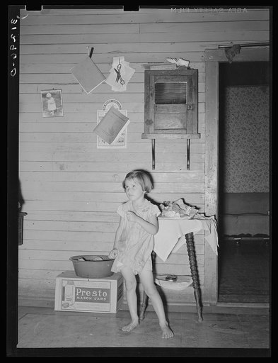 Child of sharecropper in old home. Family will work under the tenant purchase program. Near Caruthersville, Missouri