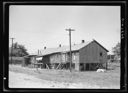 Many family houses on riverside of levee. Caruthersville, Missouri
