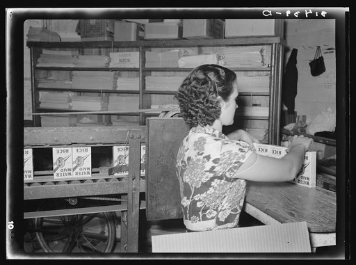 Removing packaged rice from conveyer. Ricemill, Abbeville, Louisiana