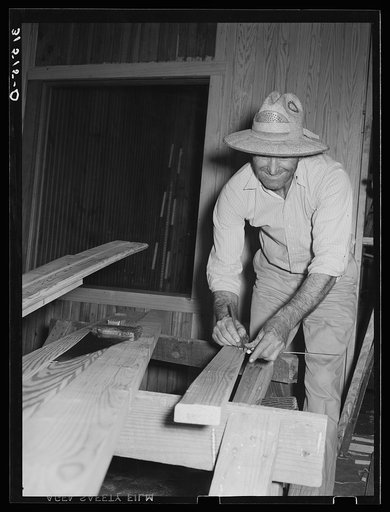 Untitled photo, possibly related to: Member of Lake Dick cooperative association installing window of partition in general store. Lake Dick Project, Arkansas
