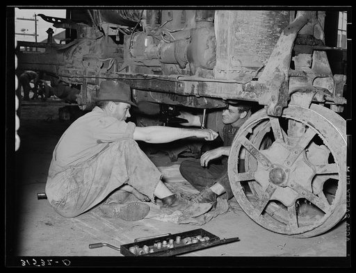 Member of cooperative association working on tractor. Lake Dick Project, Arkansas