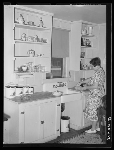 Farm wife in kitchen of new home. Lake Dick Project, Arkansas
