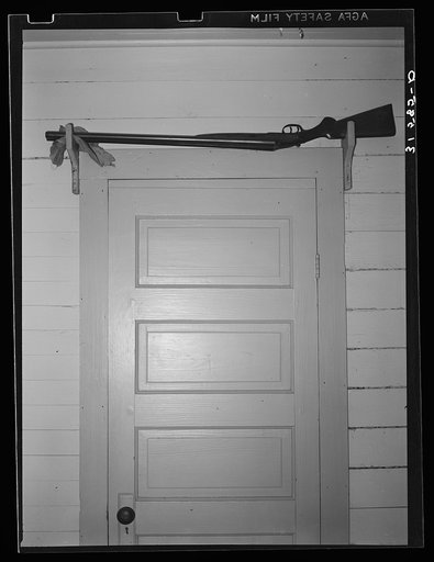 Untitled photo, possibly related to: Shotgun over the door for sake of quick availability in farmer's home. Crowley, Louisiana